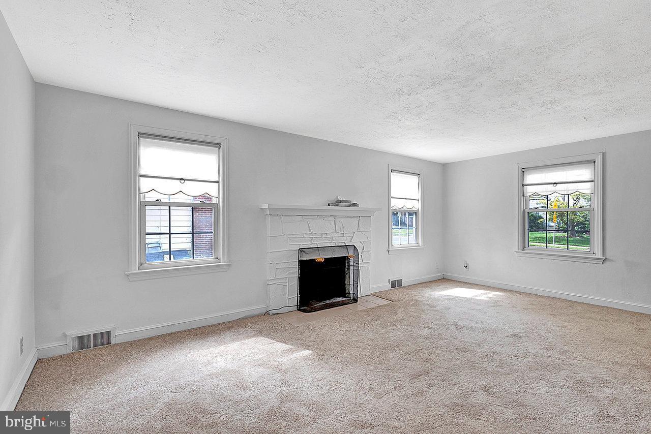 415 Sutherland Road Ewing, NJ 08618 - Photo 11 of 28 an empty room with windows and fireplace