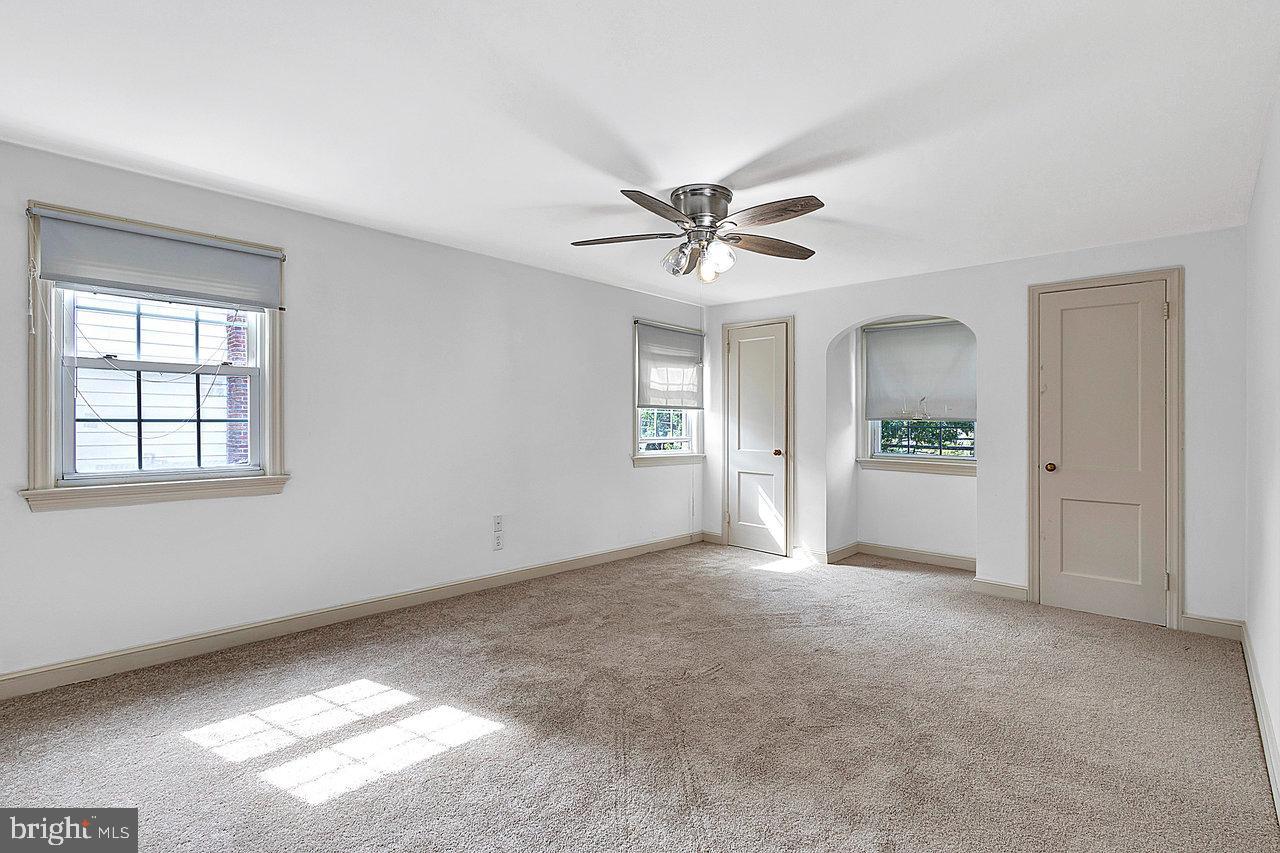 415 Sutherland Road Ewing, NJ 08618 - Photo 19 of 28 a view of a big room with windows and chandelier fan