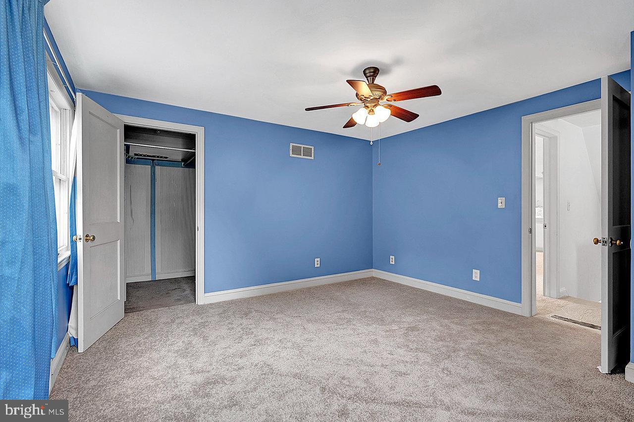 415 Sutherland Road Ewing, NJ 08618 - Photo 23 of 28 a view of an empty room with window and ceiling fan