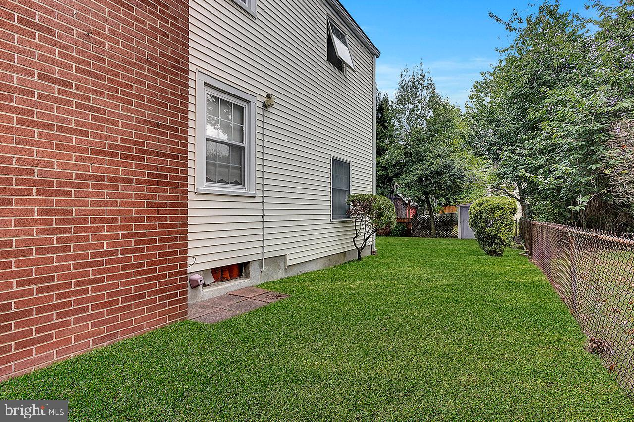 415 Sutherland Road Ewing, NJ 08618 - Photo 27 of 28 a view of a backyard with plants and a garden