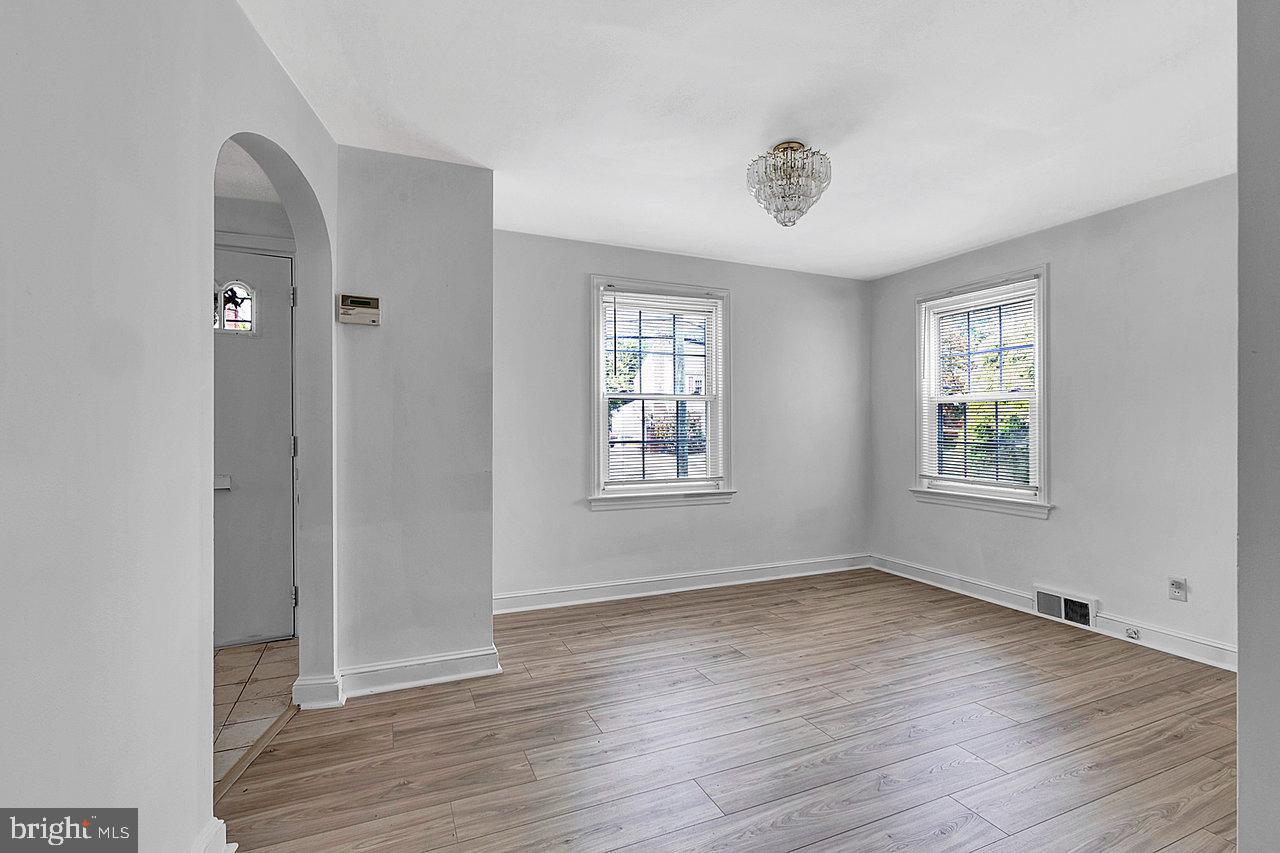 415 Sutherland Road Ewing, NJ 08618 - Photo 5 of 28 an empty room with wooden floor and windows