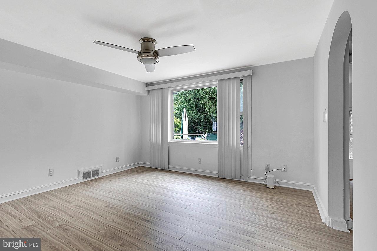 415 Sutherland Road Ewing, NJ 08618 - Photo 6 of 28 a view of an empty room with wooden floor and a window