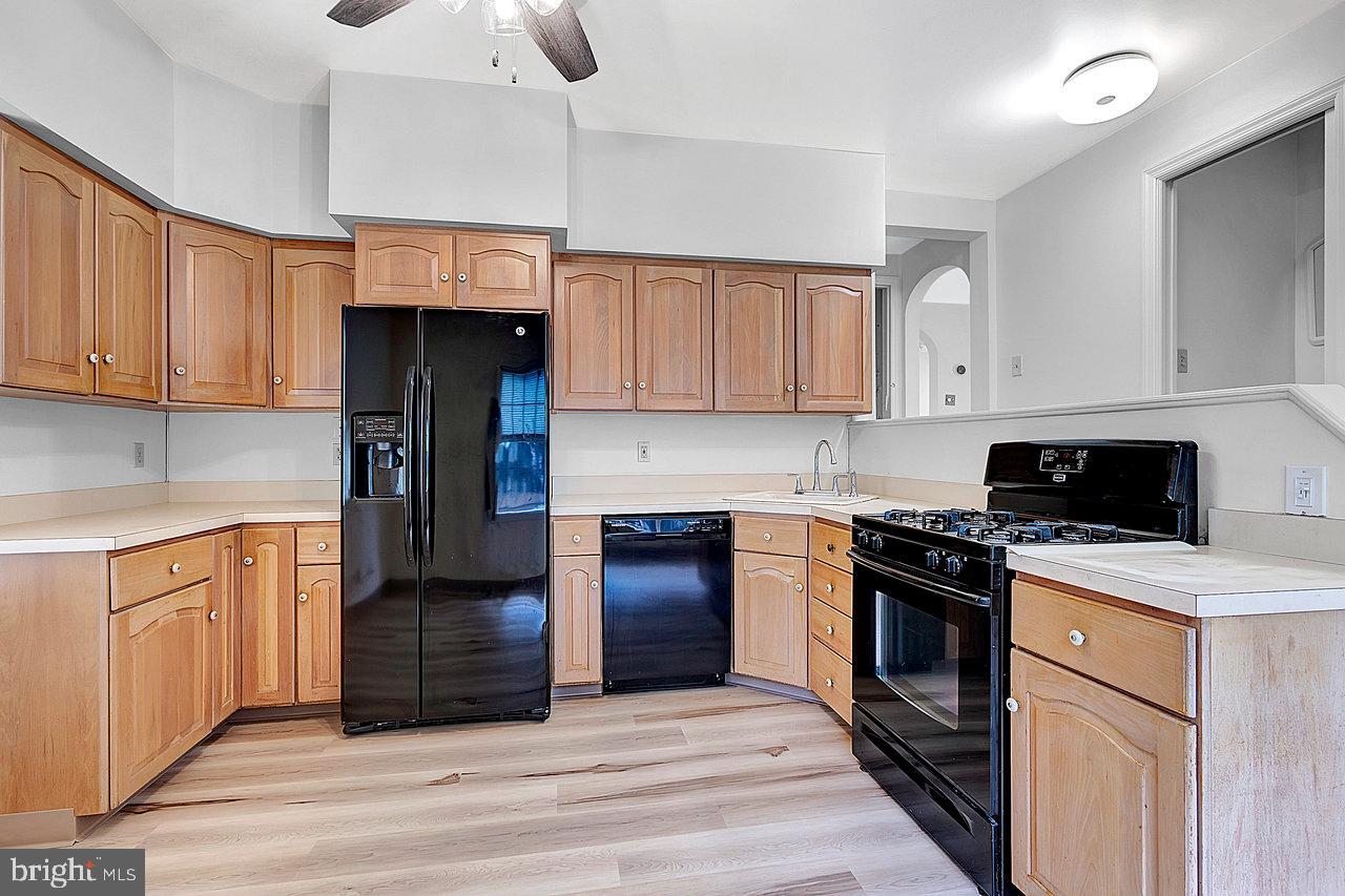 415 Sutherland Road Ewing, NJ 08618 - Photo 8 of 28 a kitchen with a stove sink and cabinets