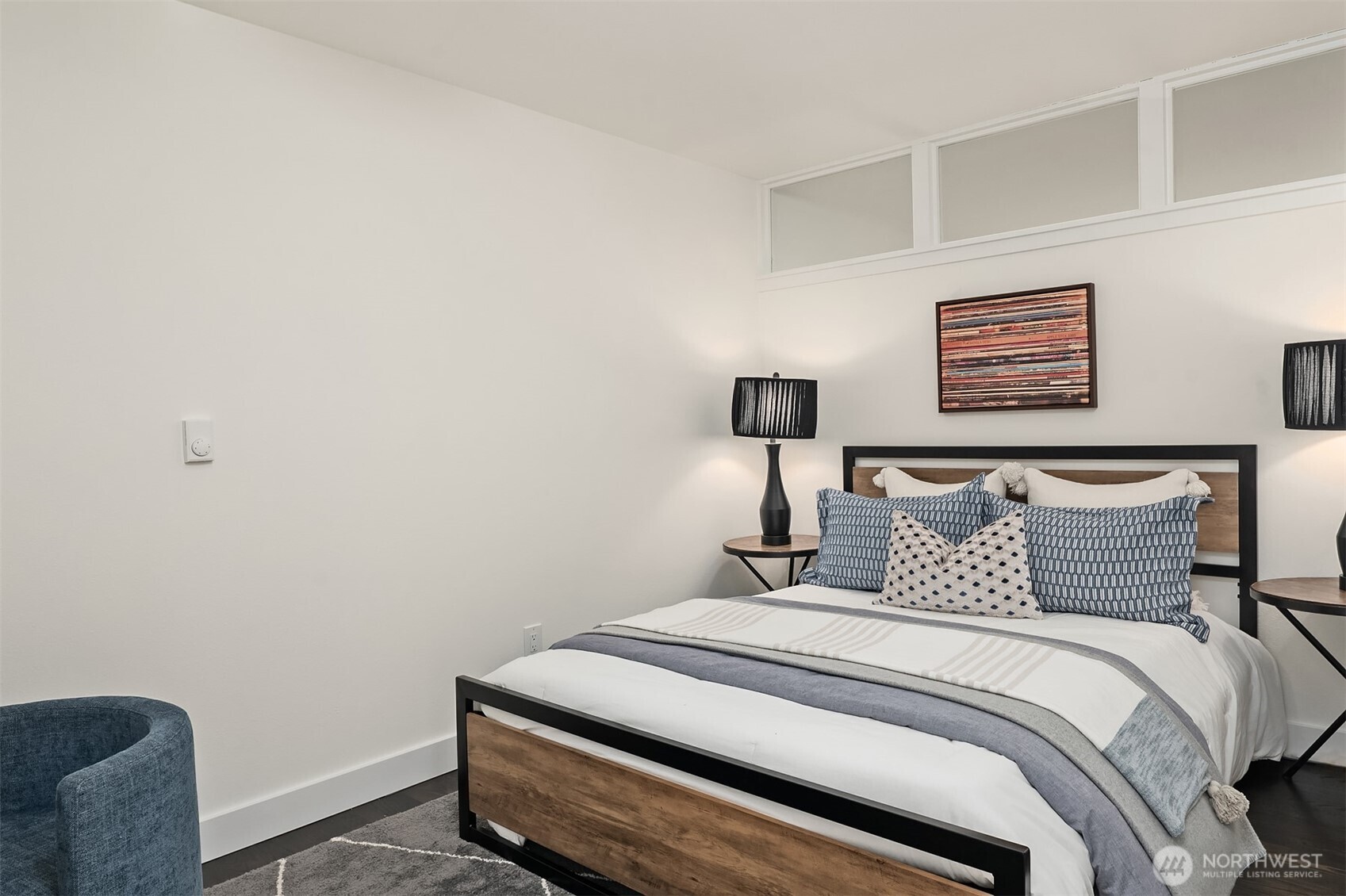 202 West Olympic Place, Unit 405 Seattle, WA 98119 - Photo 17 of 26 a bedroom with a bed and a lamp on the dresser