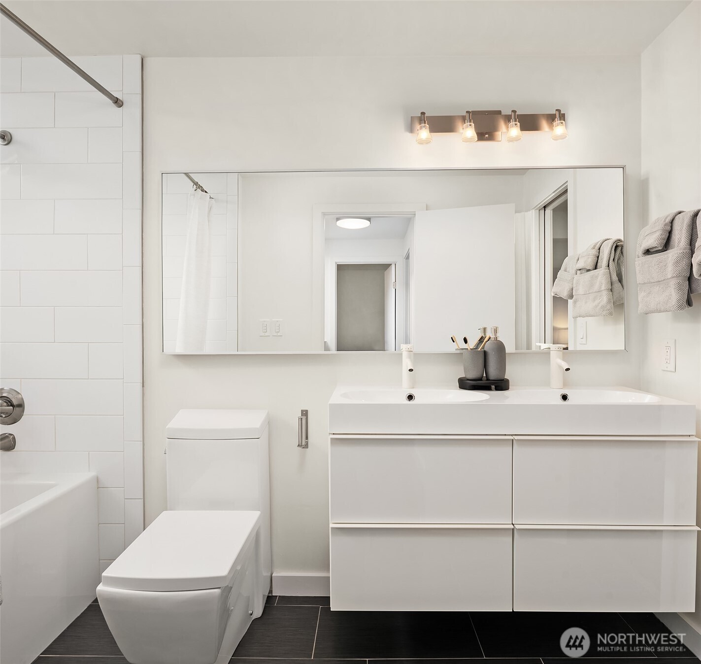 202 West Olympic Place, Unit 405 Seattle, WA 98119 - Photo 18 of 26 a bathroom with a sink a toilet and a mirror