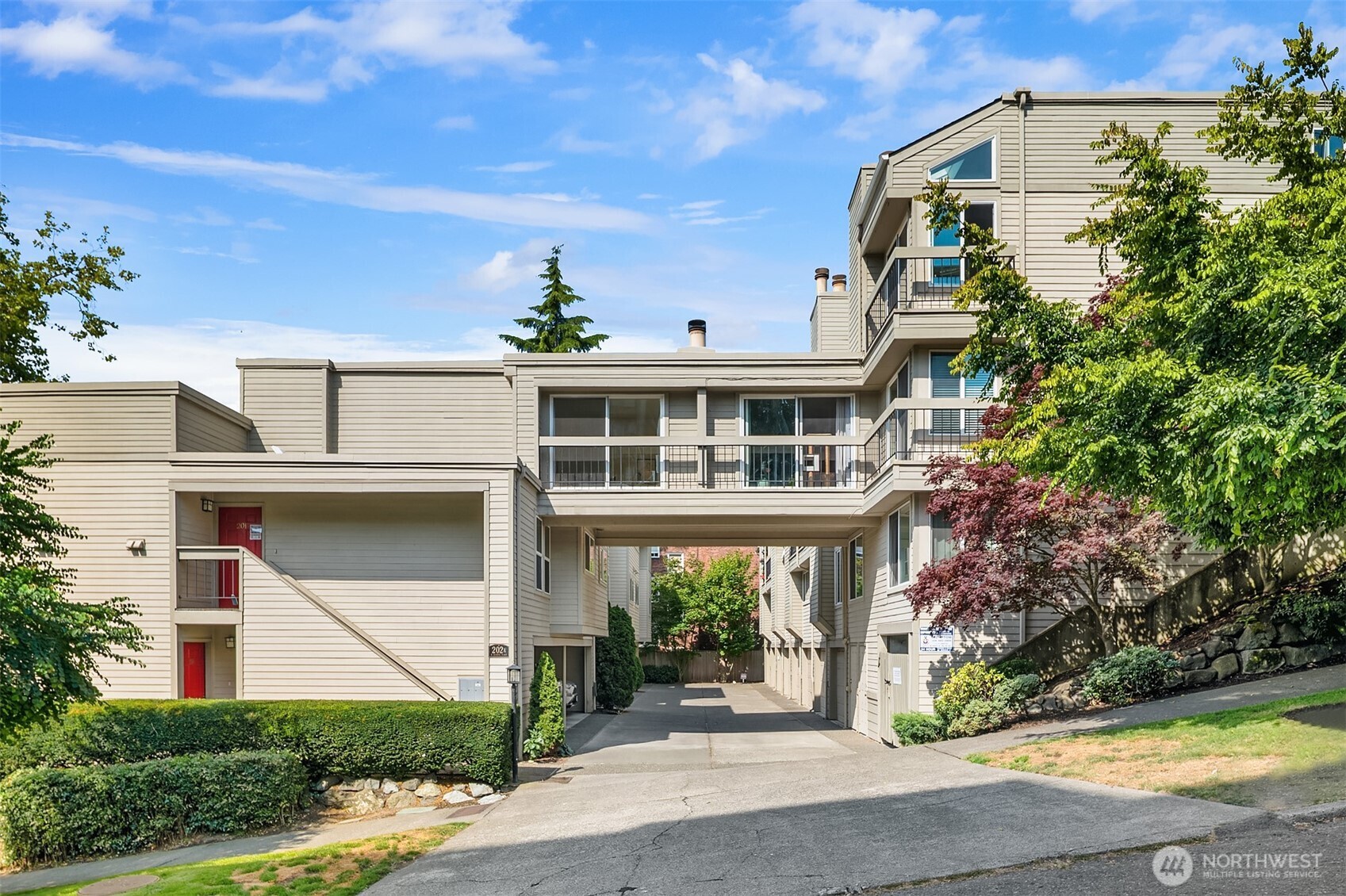 202 West Olympic Place, Unit 405 Seattle, WA 98119 - Photo 20 of 26 a front view of a building with garden