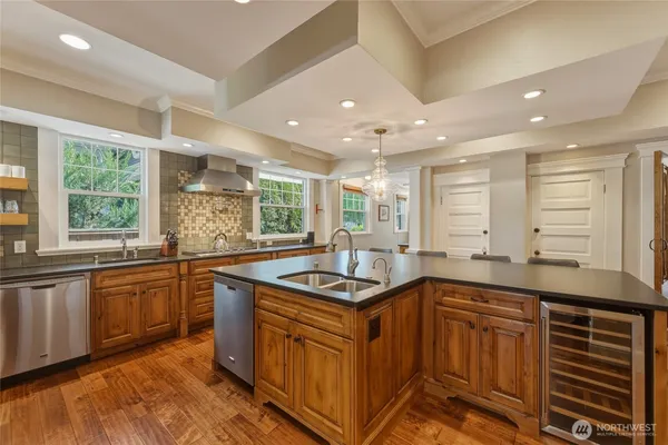 a kitchen with stainless steel appliances granite countertop a sink and stove