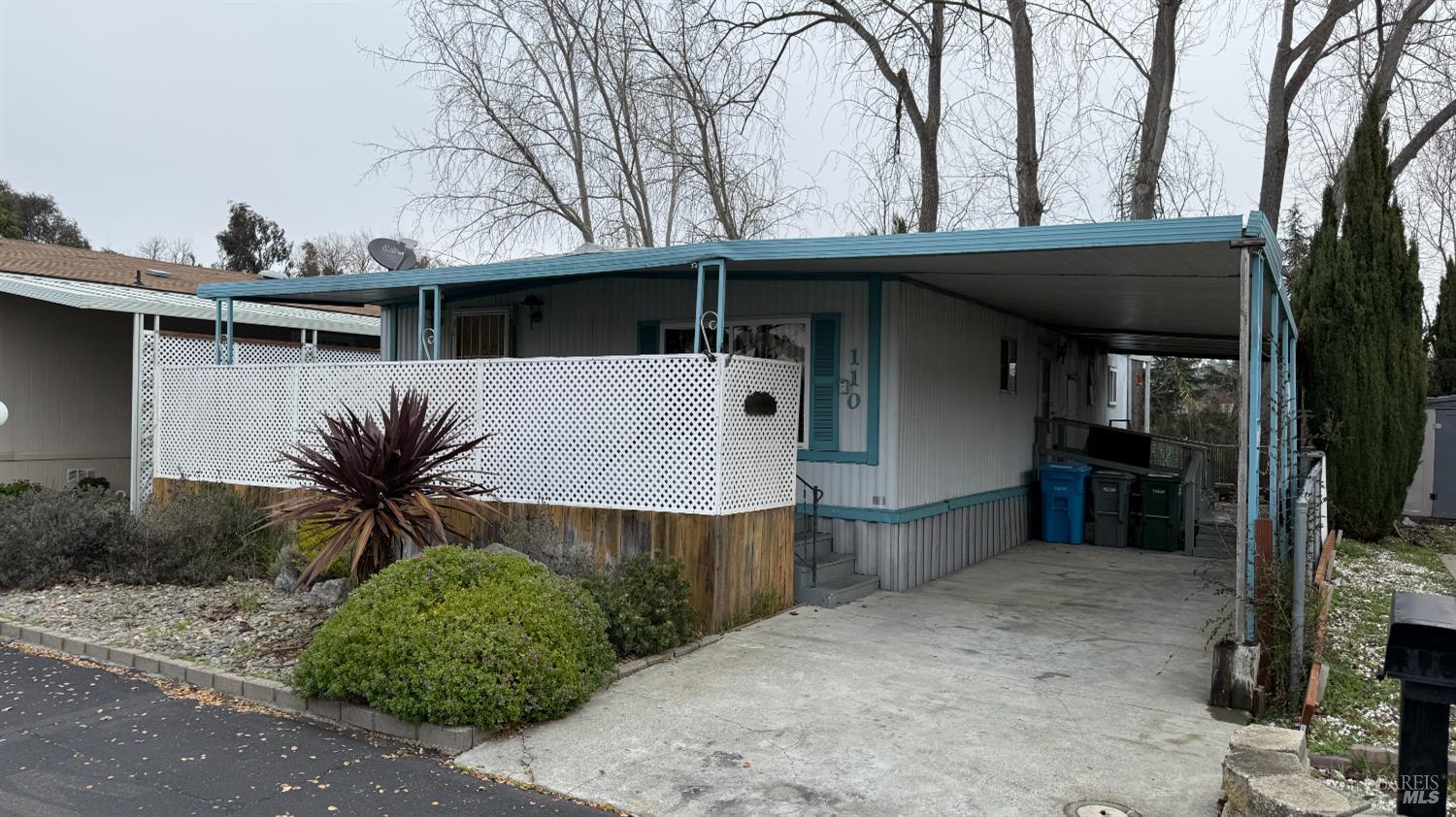 a view of a house with a yard and sitting area