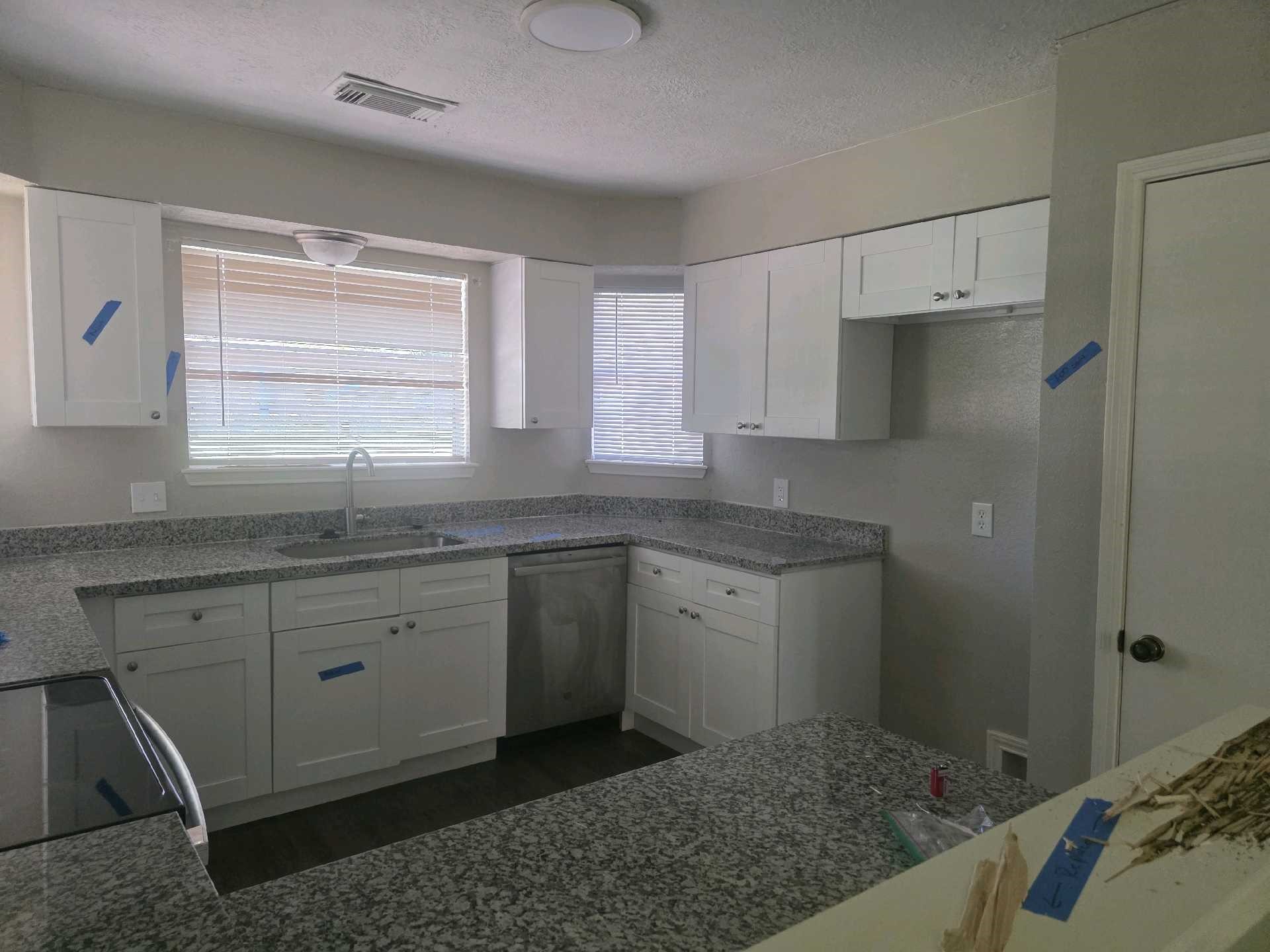 5006 Timber Ridge Street Baytown, TX 77521 - Photo 2 of 6 a kitchen with granite countertop a sink cabinets and wooden floor