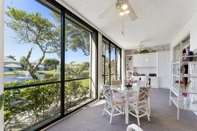 a view of an empty room with window and stairs