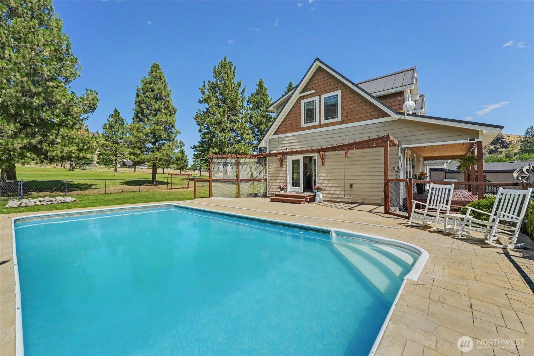 93 Golf Course Drive Pateros, WA 98846 - Photo 23 of 34 a front view of a house with swimming pool having outdoor seating