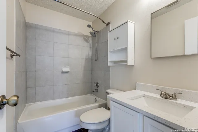 a bathroom with a sink a toilet and a bathtub