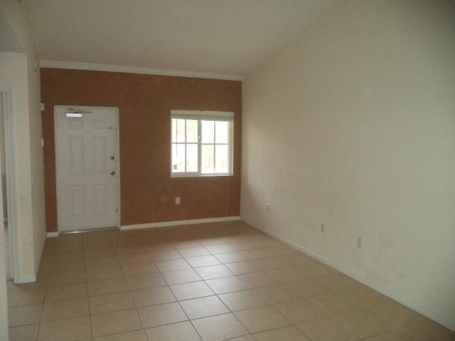 3750 North Jog Road, Unit 203 West Palm Beach, FL 33411 - Photo 7 of 10 an empty room with windows
