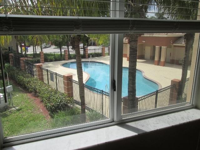3750 North Jog Road, Unit 203 West Palm Beach, FL 33411 - Photo 10 of 10 a view of a glass door with a tree