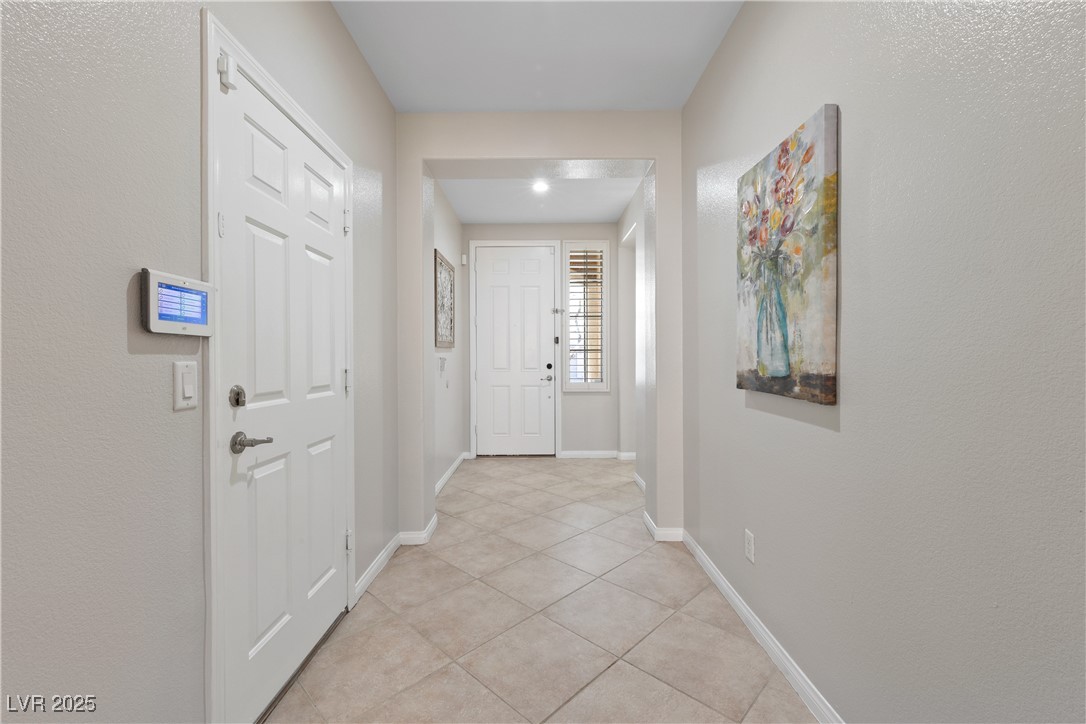 9436 Teton Ridge Avenue Las Vegas, NV 89149 - Photo 15 of 30 Doorway to outside with light tile patterned floors and baseboards