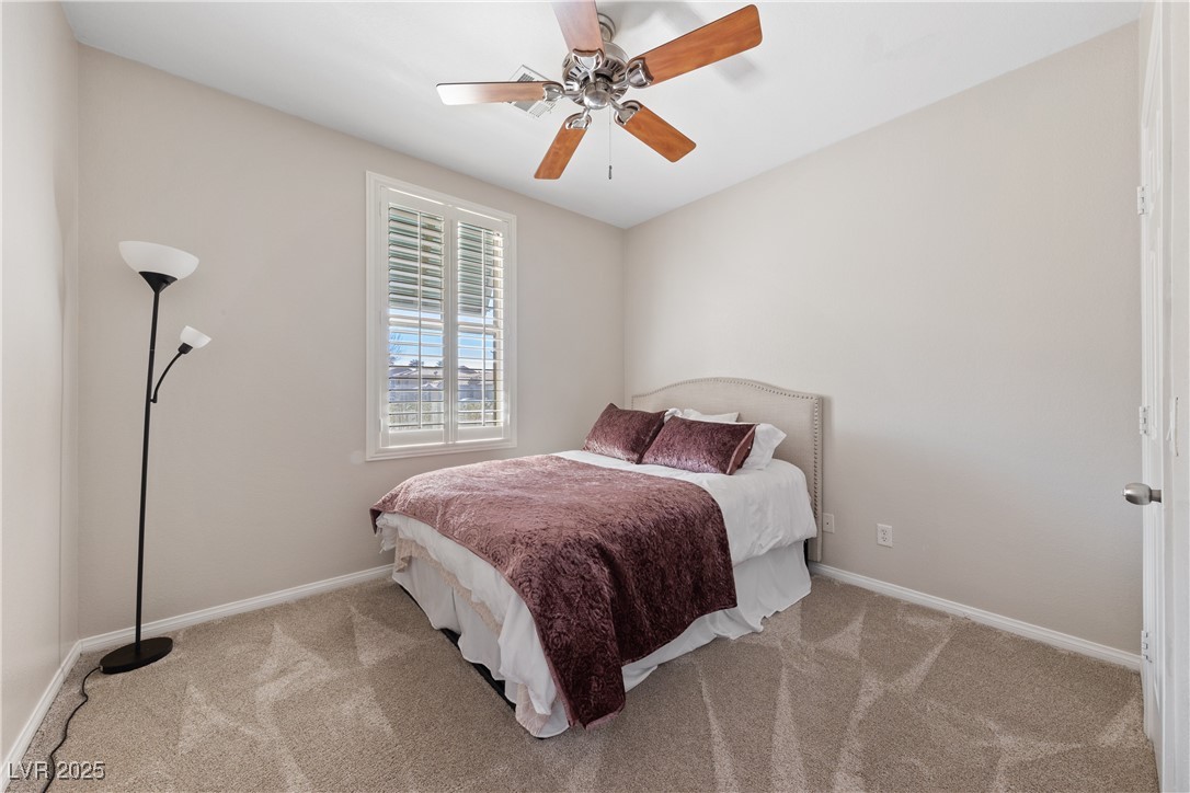 9436 Teton Ridge Avenue Las Vegas, NV 89149 - Photo 17 of 30 Carpeted bedroom with ceiling fan and baseboards