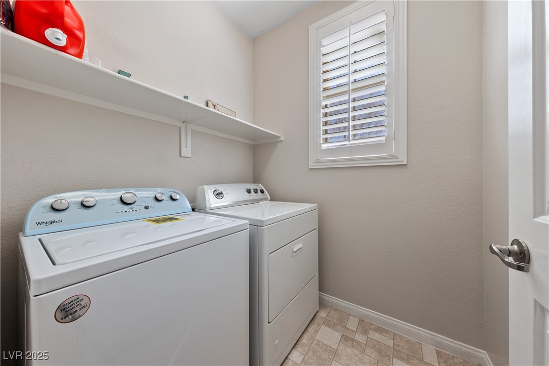 9436 Teton Ridge Avenue Las Vegas, NV 89149 - Photo 19 of 30 Washroom featuring laundry area, washer and clothes dryer, and baseboards