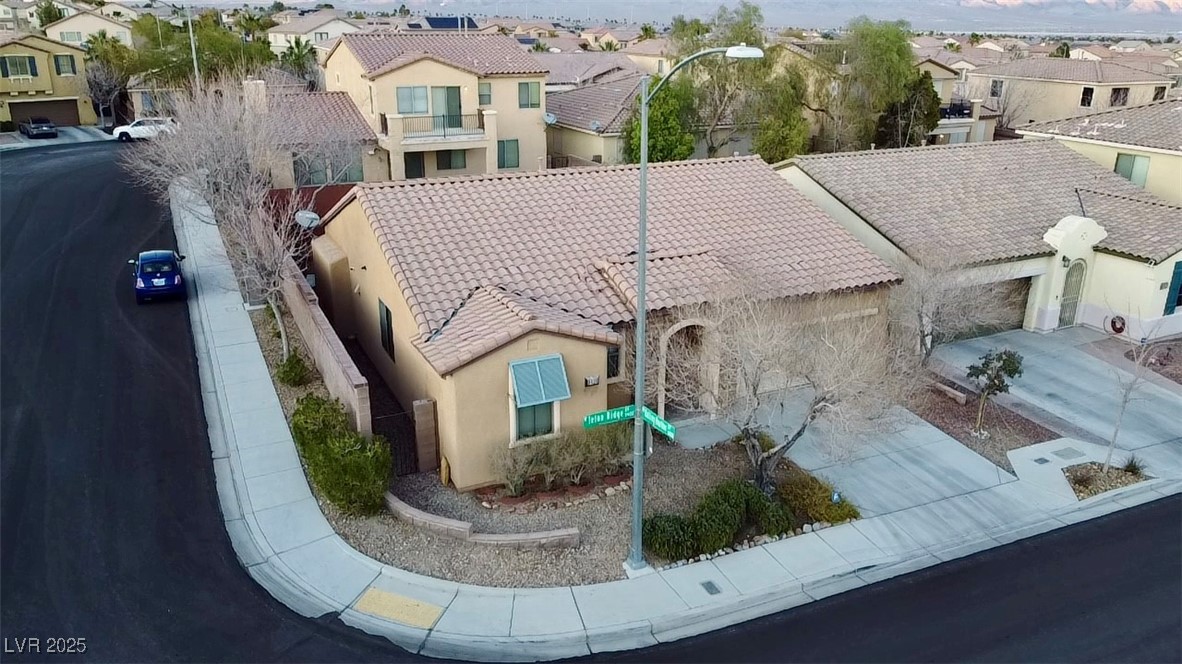 9436 Teton Ridge Avenue Las Vegas, NV 89149 - Photo 30 of 30 View of front of house with a tile roof, stucco siding, an attached garage, a residential view, and driveway