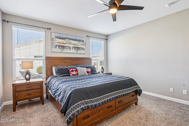an aerial view of a city with lots of residential buildings and ocean view in back