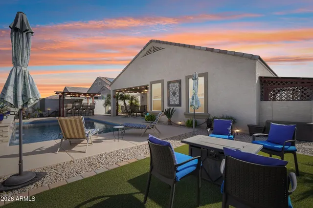 a front view of a house with a yard and potted plants