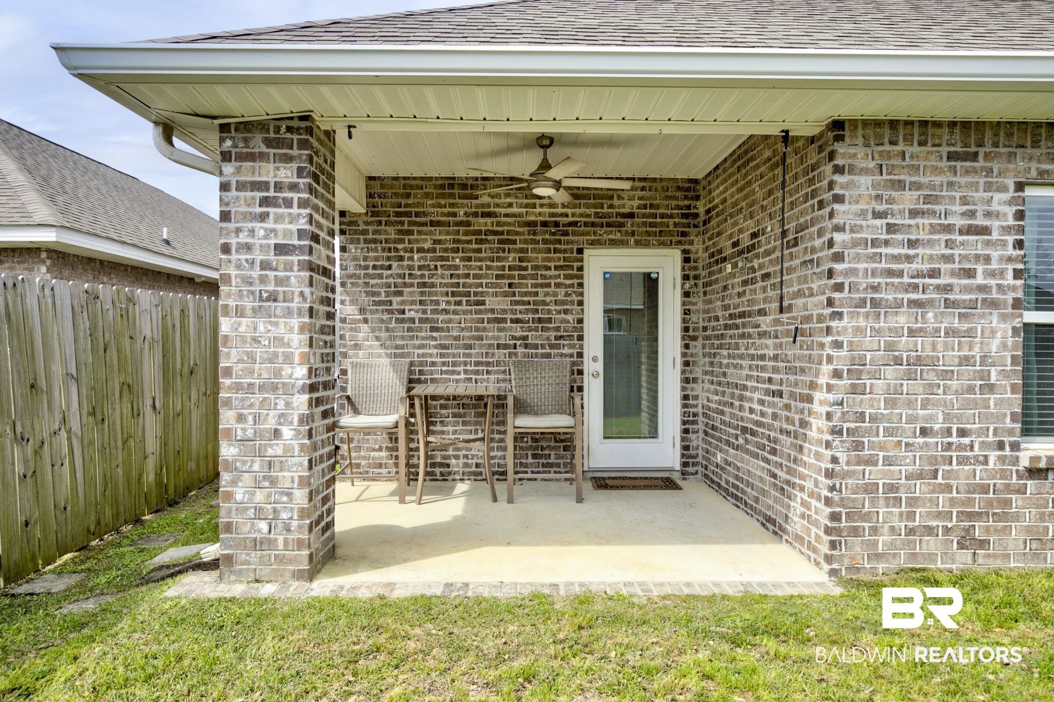 31610 Memphis Loop Daphne, AL 36527 - Photo 35 of 67 View of patio featuring a ceiling fan and fence