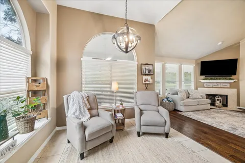 a living room with fireplace furniture and a flat screen tv