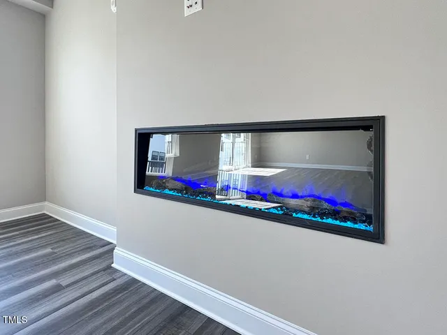 a living room with blue wall painting and a potted plant