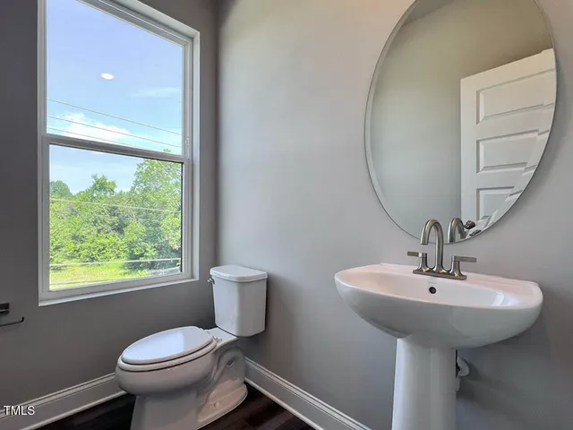 a bathroom with a sink toilet and a mirror