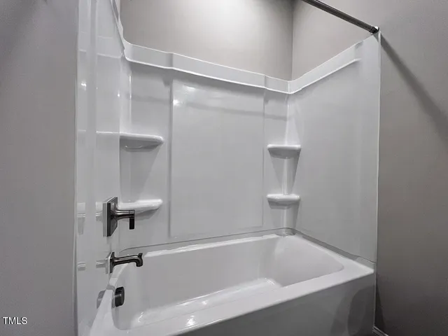 a spacious bathroom with a double vanity sink a mirror and a toilet