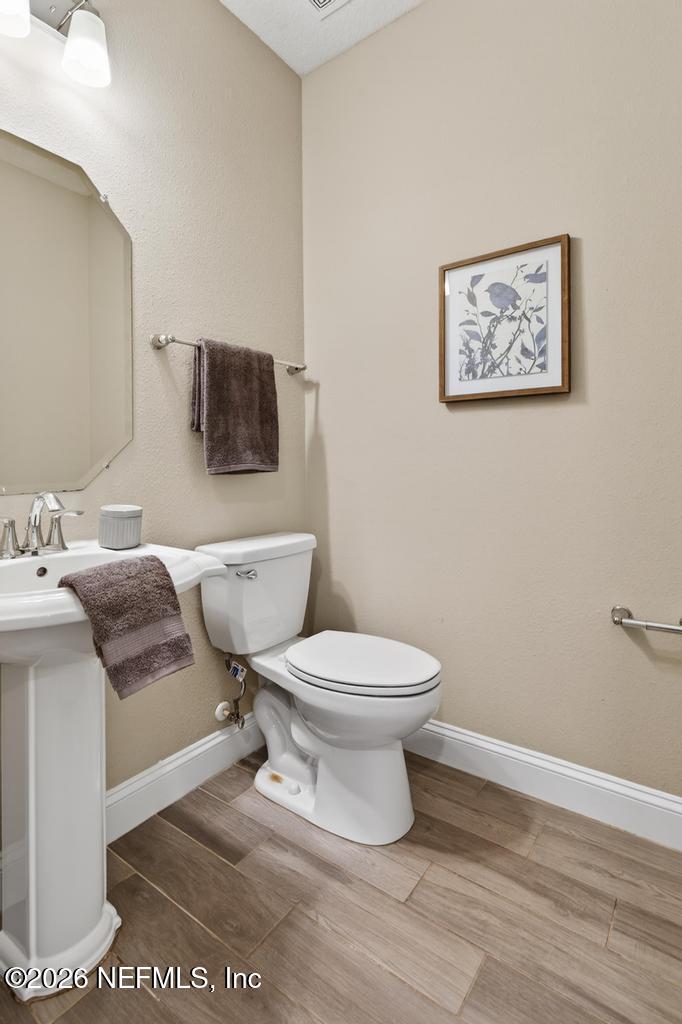 383 Sweet Oak Way St. Augustine, FL 32095 - Photo 11 of 74 a white toilet sitting next to a bathroom sink