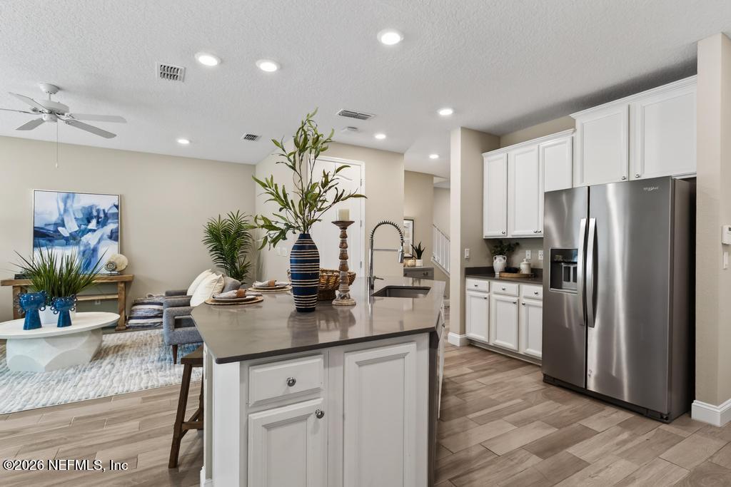 383 Sweet Oak Way St. Augustine, FL 32095 - Photo 16 of 74 a kitchen with refrigerator and stove