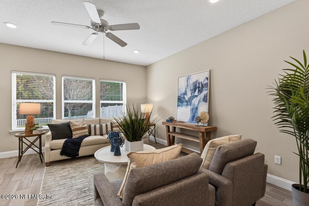 383 Sweet Oak Way St. Augustine, FL 32095 - Photo 20 of 74 a living room with furniture and a large window