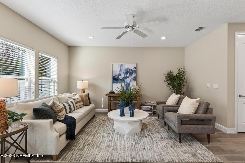 383 Sweet Oak Way St. Augustine, FL 32095 - Photo 21 of 74 a living room with furniture and a large window