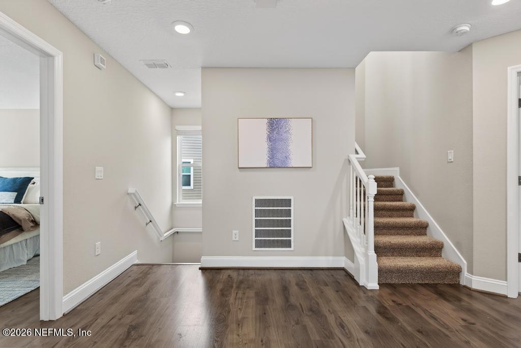 383 Sweet Oak Way St. Augustine, FL 32095 - Photo 29 of 74 a view of a livingroom with wooden floor and stairs