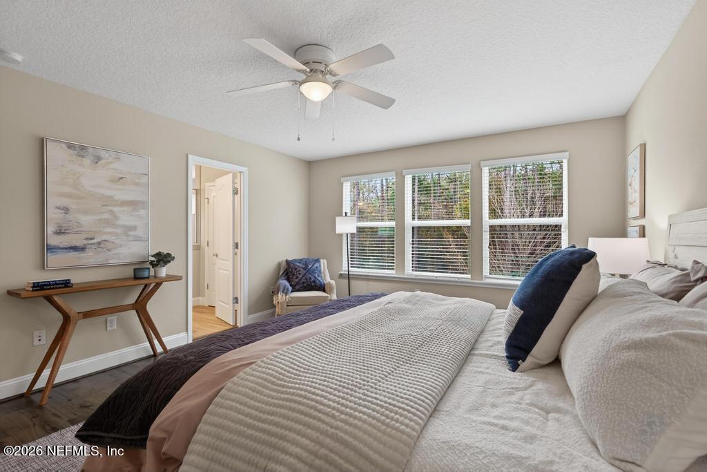 383 Sweet Oak Way St. Augustine, FL 32095 - Photo 34 of 74 a bedroom with a bed and a large window with chair