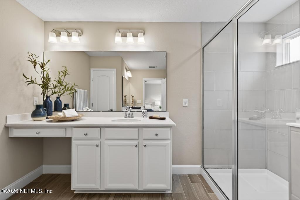 383 Sweet Oak Way St. Augustine, FL 32095 - Photo 39 of 74 a bathroom with a sink and a mirror