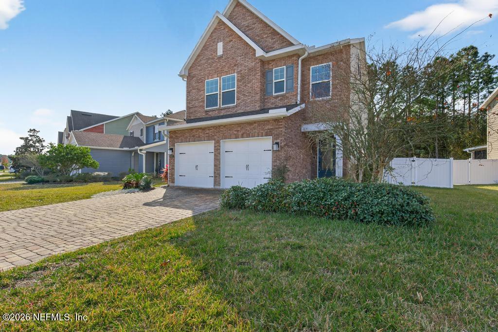 383 Sweet Oak Way St. Augustine, FL 32095 - Photo 4 of 74 a view of a house with a yard and a large tree