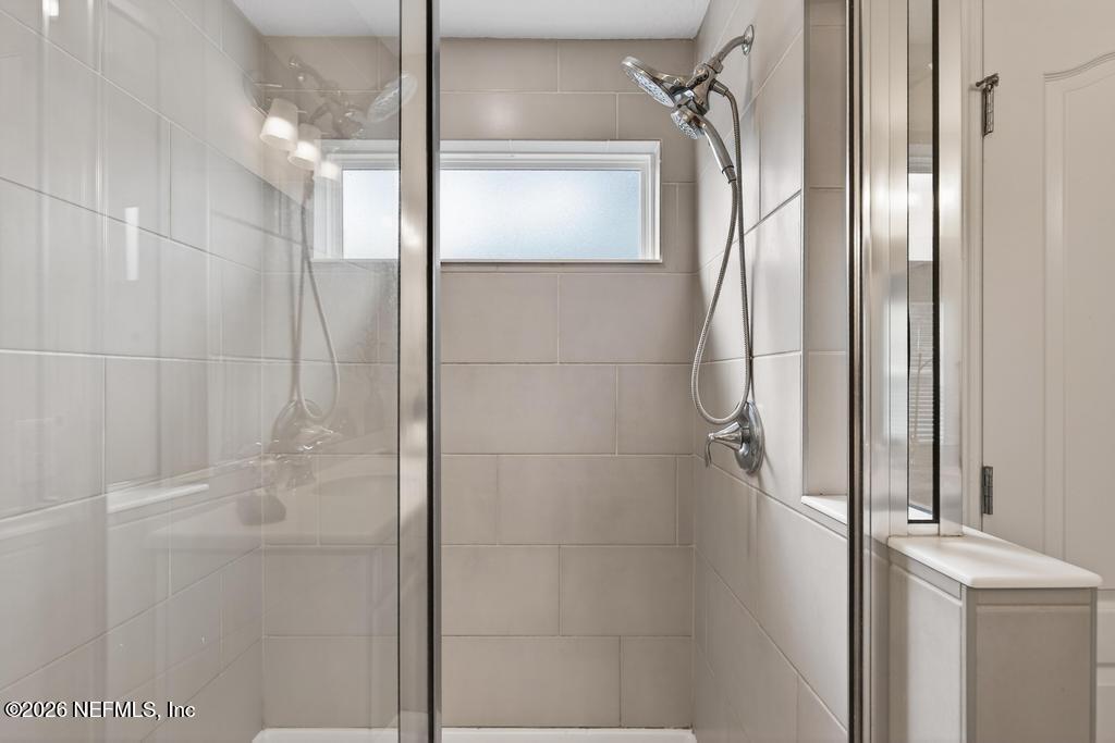 383 Sweet Oak Way St. Augustine, FL 32095 - Photo 42 of 74 a bathroom with a glass shower door and a shower