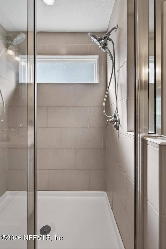 383 Sweet Oak Way St. Augustine, FL 32095 - Photo 43 of 74 a bathroom with a glass shower door