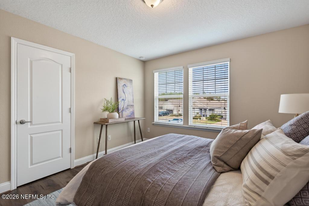 383 Sweet Oak Way St. Augustine, FL 32095 - Photo 52 of 74 a bedroom with a bed and a window