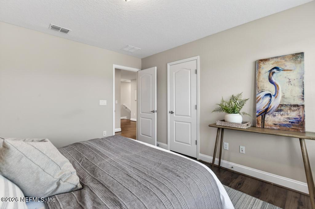 383 Sweet Oak Way St. Augustine, FL 32095 - Photo 53 of 74 a bedroom with a bed and hallway