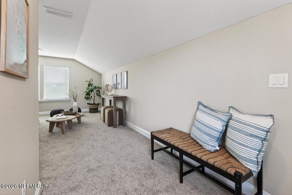 383 Sweet Oak Way St. Augustine, FL 32095 - Photo 57 of 74 a living room with furniture a rug and a table