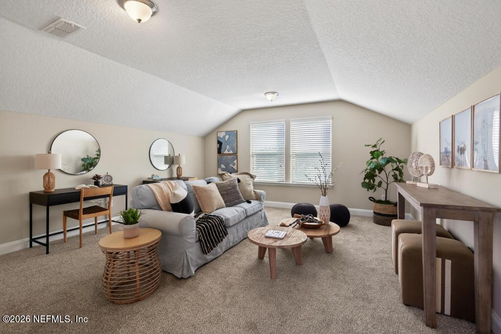 383 Sweet Oak Way St. Augustine, FL 32095 - Photo 58 of 74 a living room with furniture a table and a large window
