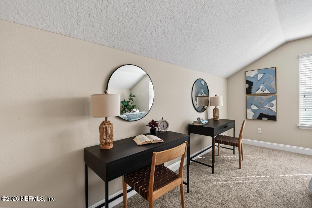 383 Sweet Oak Way St. Augustine, FL 32095 - Photo 60 of 74 a dining room with furniture and a mirror