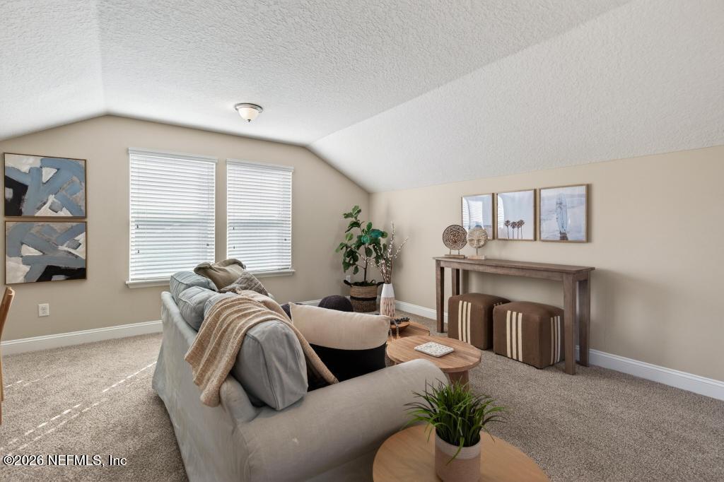 383 Sweet Oak Way St. Augustine, FL 32095 - Photo 61 of 74 a living room with furniture and a fireplace