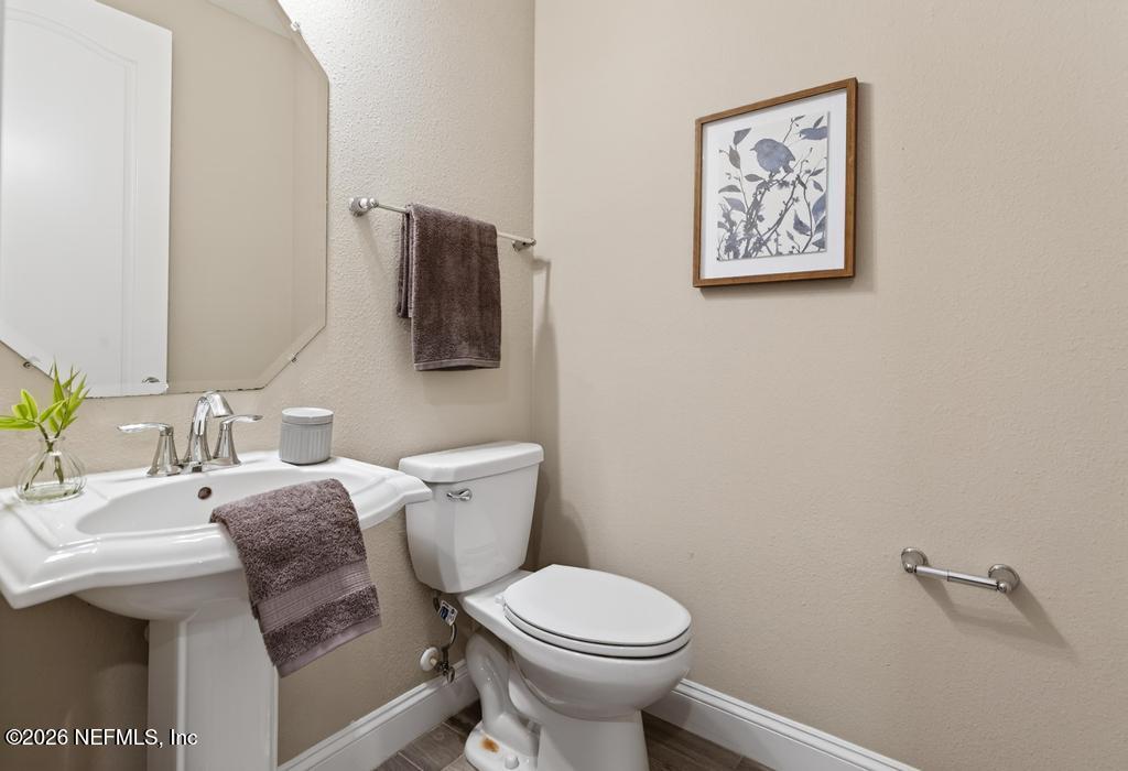383 Sweet Oak Way St. Augustine, FL 32095 - Photo 10 of 74 a bathroom with a toilet sink and mirror
