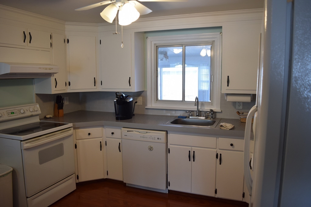 475 Cedar Avenue Swansea, MA 02777 - Photo 11 of 42 a kitchen with white cabinets and sink