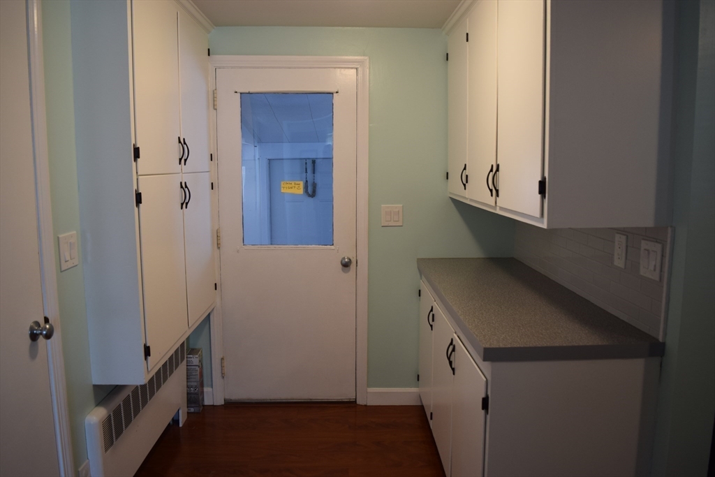 475 Cedar Avenue Swansea, MA 02777 - Photo 12 of 42 a storage room with wooden floor washer and dryer