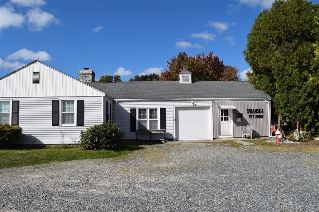 475 Cedar Avenue Swansea, MA 02777 - Photo 4 of 42 a front view of a house with a yard and garage
