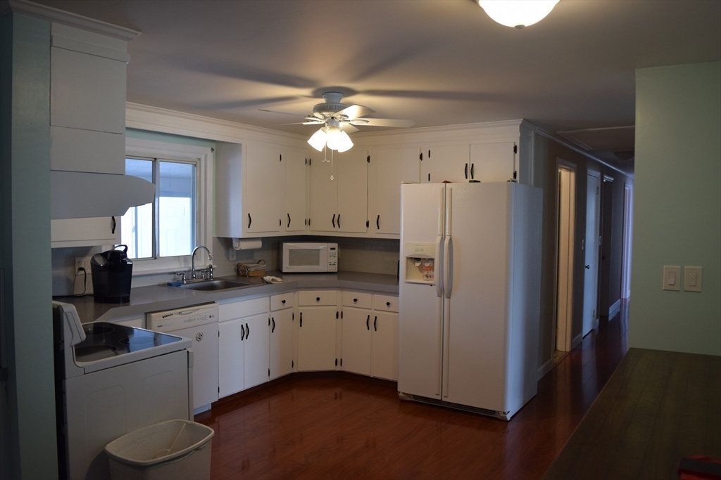 475 Cedar Avenue Swansea, MA 02777 - Photo 10 of 42 a kitchen with white cabinets and stainless steel appliances